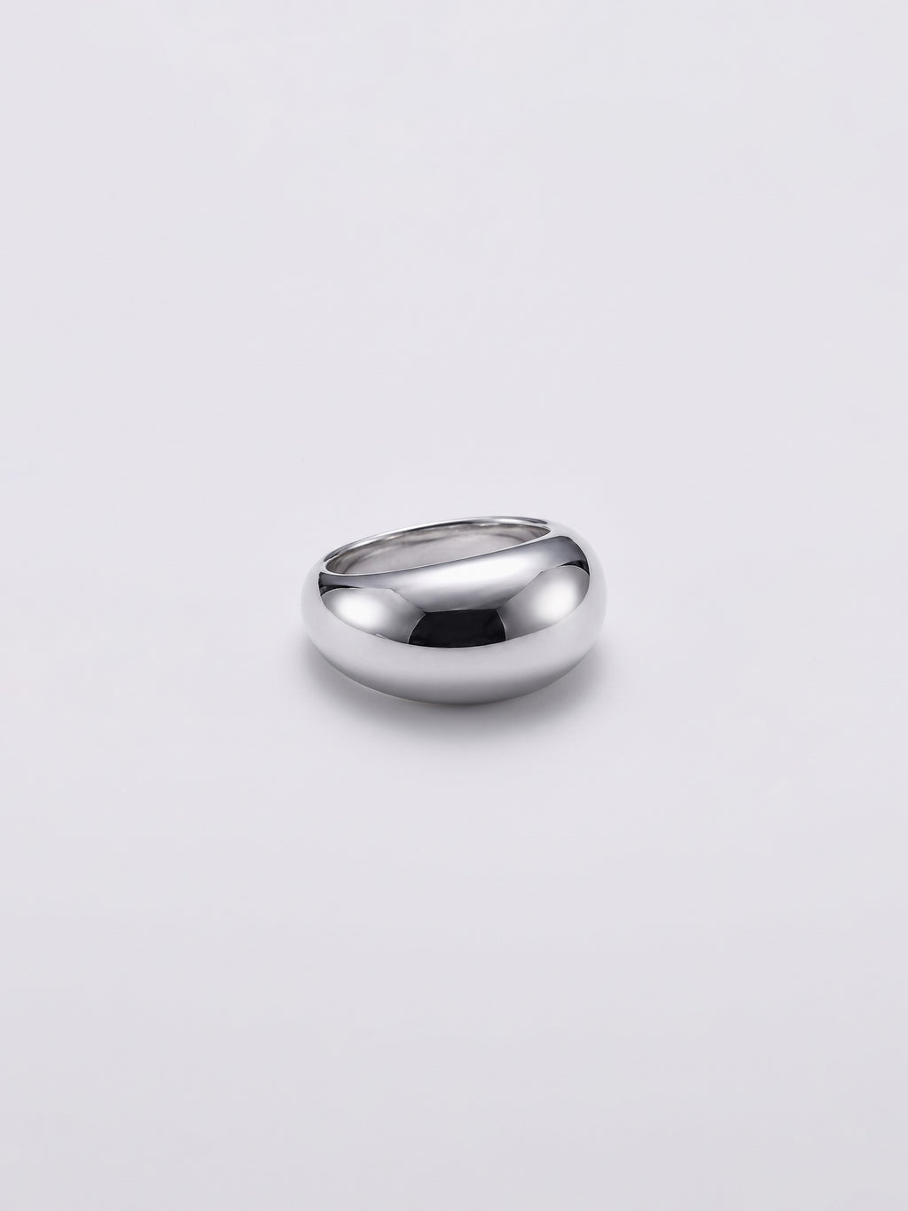 A polished silver dome ring with a smooth, rounded shape, photographed on a clean light gray background.