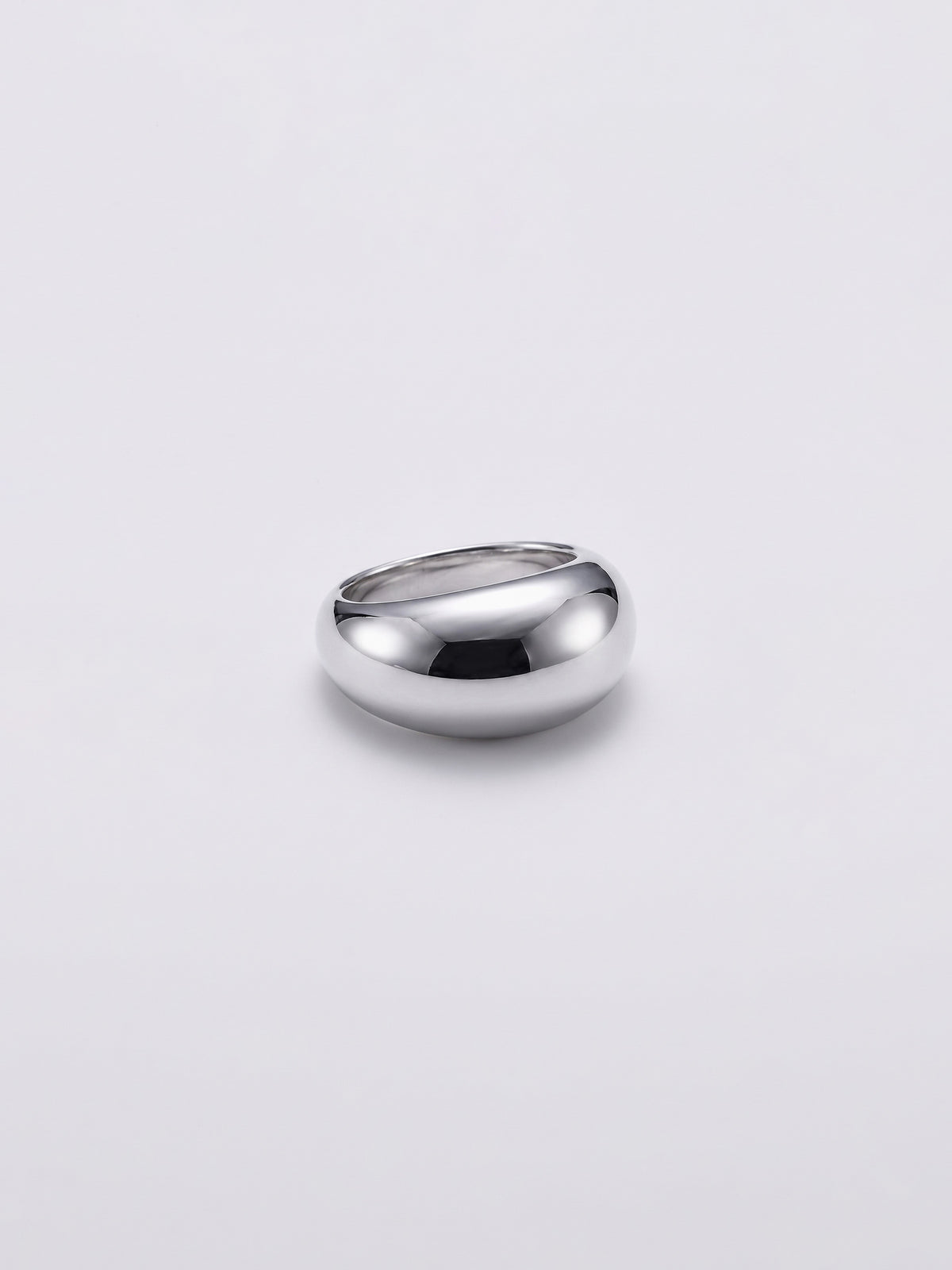 A polished silver dome ring with a smooth, rounded shape, photographed on a clean light gray background.