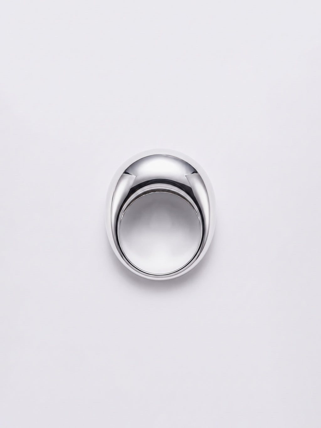 A polished silver dome ring with a smooth, reflective finish, centered on a light gray background.