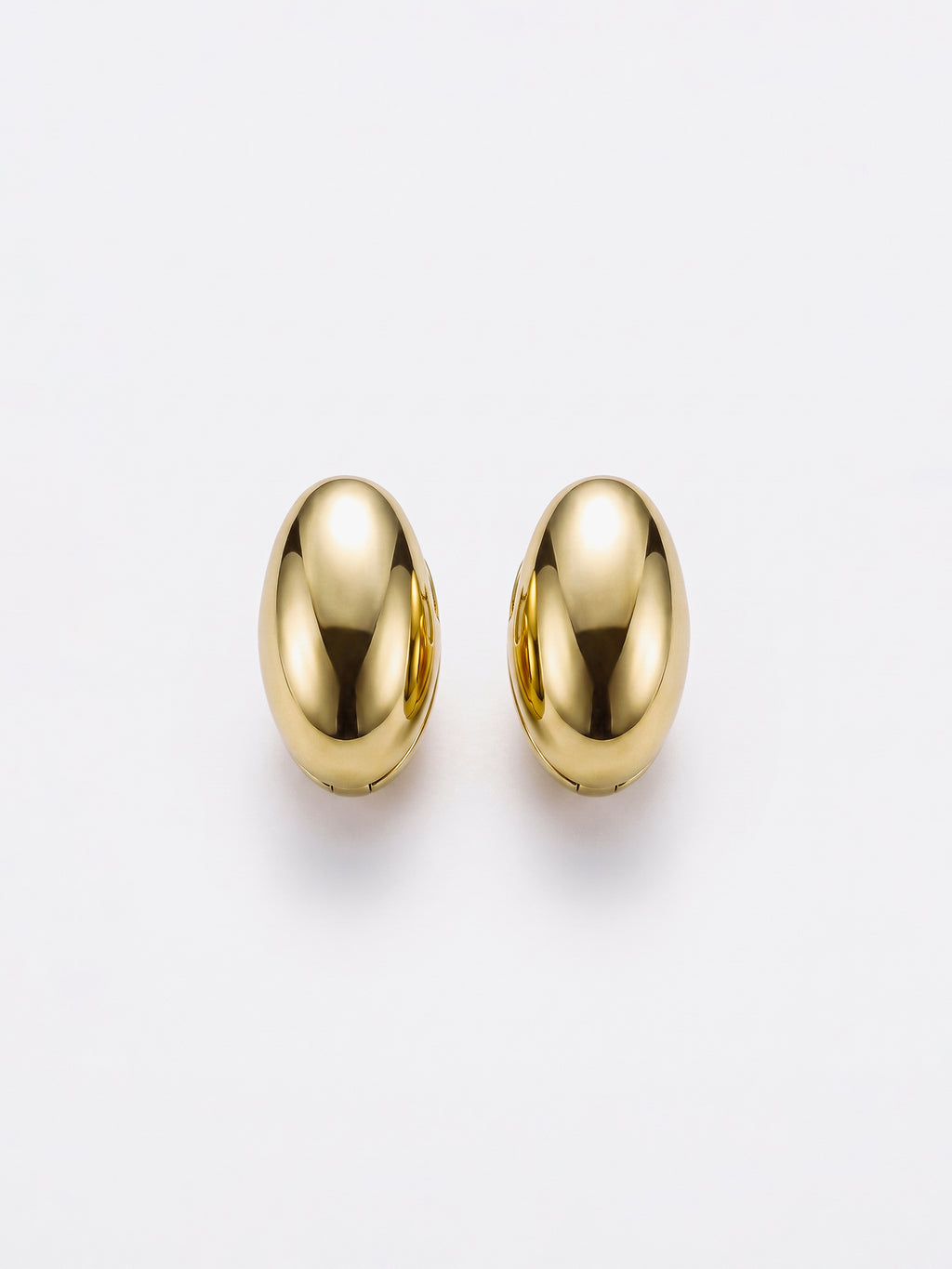 A pair of gold egg shaped earrings with a polished, metallic finish, displayed against a clean white background.