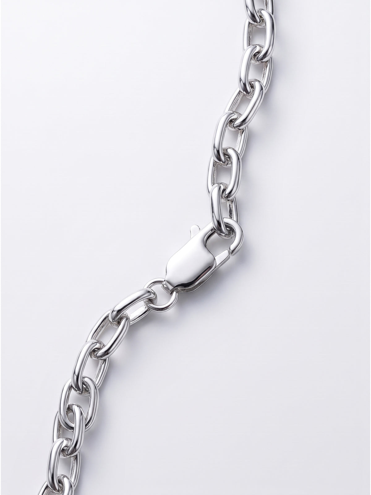 A close-up of a polished silver link chain with a lobster clasp, shown against a clean light gray background.